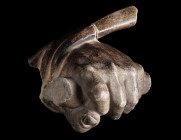 AN ANTIQUE MARBLE HAND FROM A STATUE
Circa 16th-17th century AD.
Finely modelled male hand holding an attribute/implement, from a well under-life-si...