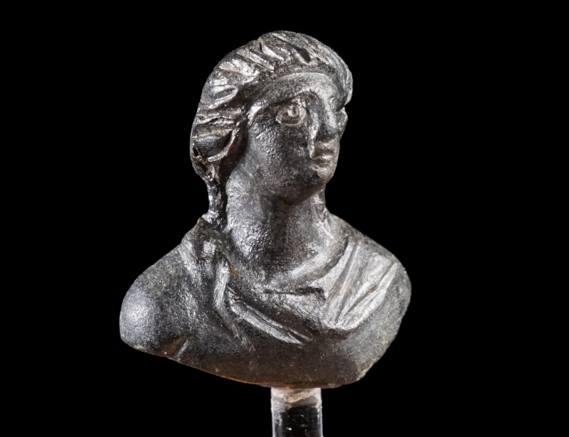 A ROMAN BRONZE BUST APPLIQUE OF A HERO
Circa 1st-3rd century AD.
Small bust of...