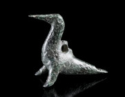 A GEOMETRIC BRONZE PENDANT OF A BIRD
Circa 8th-7th century BC.
Stylised bird with a long, pointed beak; with a suspension loop on the back of the bo...