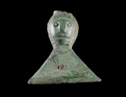 A LATE ROMAN BRONZE BELT FITTING WITH A FACE
Circa 4th-5th century AD.
Belt fitting with a stylised human face; with rivet for attachment. Upper par...