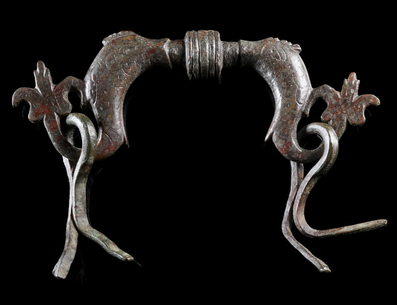 A ROMAN BRONZE CHEST HANDLE WITH TWO DOLPHINS
Circa 1st-3rd century AD.
Handle...
