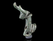 AN ARCHAIC BRONZE ATTACHMENT IN THE SHAPE OF A BULL
Circa 9th-7th century BC.
Bull protome, pierced for attachment and with a further suspension loo...