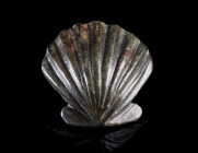 A ROMAN BRONZE APPLIQUE IN THE FORM OF A SHELL
Circa 1st-3rd century AD.
Applique in the shape of a scallop, with a stud for attachment on the back....