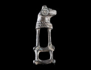 A BYZANTINE BRONZE CLASP WITH A HORSE HEAD
Circa 8th-12th century AD.
Clasp with a stylised horse head to right; incised and punched decoration.
L ...