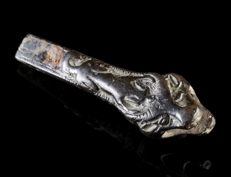 A BRONZE HANDLE WITH DOG AND BULL
Circa 16th-18th century AD.
Handle with a bu...
