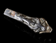 A BRONZE HANDLE WITH DOG AND BULL
Circa 16th-18th century AD.
Handle with a bull's head and a dog in high relief on top/behind it on either side at ...