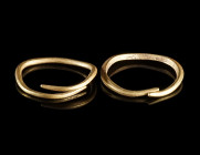 TWO EUROPEAN BRONZE AGE GOLD RINGS
Circa 12th-10th century BC.
Two rings made from gold wire. Both with tapering ends; one square in section.
Diame...