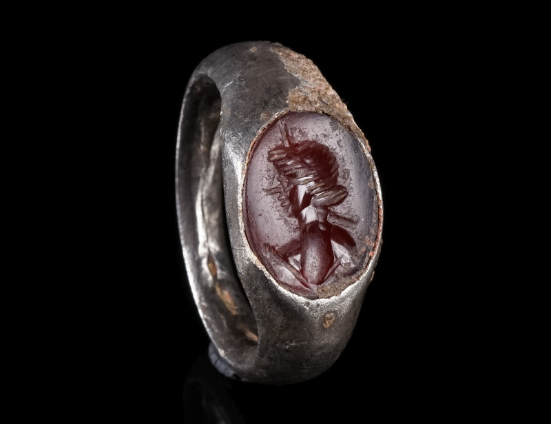 A ROMAN SILVER RING WITH A CARNELIAN INTAGLIO
Circa 1st-2nd century AD.
Solid ...