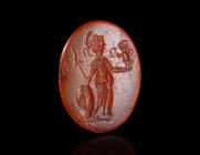 A ROMAN CARNELIAN INTAGLIO DEPICTING MINERVA
Circa 1st-3rd century AD.
Oval intaglio with the helmeted and draped goddess standing to right, holding...