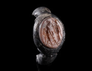 A ROMAN SILVER RING WITH ASCLEPIUS AND SALUS
Circa 2nd-3rd century AD.
Silver ring with a Carnelian intaglio depicting a stylised representation of ...