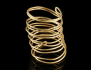 A EUROPEAN BRONZE AGE GOLD SPIRAL
Circa 12th-9th century BC.
Made from a continuous loop of gold wire doubled up and bent into a spiral.
H 35 mm; G...