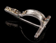AN ELABORATELY DECORATED ROMAN SILVER BROOCH
Circa second half of 3rd century AD.
Brooch with arched bow and tubular foot. Bow and foot elaborately ...