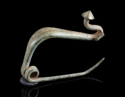 AN IRON AGE/EASTERN CELTIC BRONZE BOW FIBULA
Circa 4th-3rd century BC.
La Tène Type/Thracian Type fibula. Made of one piece with spring and pin; the...