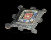 A ROMAN ENAMELLED BRONZE PLATE BROOCH
Circa 2nd century AD.
A lozenge-shaped plate brooch, the front face decorated with fields of blue, white, and ...