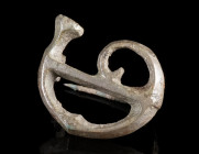 A ROMAN BRONZE MILITARY HORN BROOCH
Circa 2nd-3rd century AD.
Openwork plate brooch in the shape of a cornu, a Roman horn that was mainly used in th...
