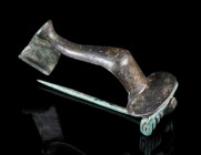 A LARGE ROMAN BRONZE KNEE BROOCH
Circa 2nd-3rd century AD.
With semicircular head plate. Spring and pin.
L 55 mm

Acquired on the UK art market.