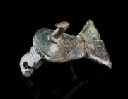 A LATE ROMAN BRONZE BIRD BROOCH
Circa 3rd-4th century AD.
Brooch in the shape of a bird with folded wings and fantail. The body decorated with ring-...