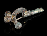 A LATE ROMAN GILT BRONZE CROSSBOW BROOCH
Circa 4th century AD.
With arched bow and facetted onion-shaped terminals ('Zwiebelknöpfe'). The foot is de...