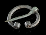A BALTIC VIKING BRONZE PENANNULAR BROOCH
Circa 9th-11th century AD.
Small brooch with coiled profiled ends.
Diameter 23 mm (max.)

Austrian priva...