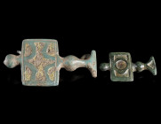 TWO PARTS OF CELTIC LA TENE PERIOD BRONZE FIBULAE
Circa 3rd century BC.
Two attachments with enamelled rectangular plates from Celtic fibulae, origi...