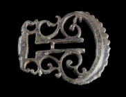 A FINE ROMAN BRONZE BELT BUCKLE FROM A MILITARY BELT
Circa 2nd-3rd century AD.
Belt buckle with an intricate openwork design from a Roman military b...