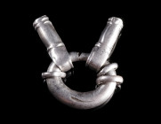 A MIGRATION PERIOD SILVER STRAP DIVIDER
Circa 5th-6th century AD.
Buckle-shaped divider with two fittings to accommodate the strap ends.
L 31 mm (t...