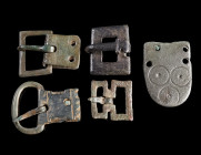 A GROUP OF FOUR SMALL BRONZE BUCKLES AND A STRAP END
Circa 1st-4th century AD.
Roman to Late Antique period. The strap end decorated with ring-and-d...