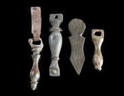 TWO ROMAN BRONZE PENDANTS AND TWO BELT FITTINGS
Circa 1st-3rd century AD.
Two profiled pendants from a belt, and two bronze belt fittings. One fitti...