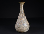 A ROMAN PALE YELLOW-GREEN GLASS FLASK
Circa 2nd-3rd century AD.
Flask with pear-shaped body, cylindrical neck, and flared mouth with thickened rim. ...
