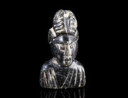 A ROMAN JET PENDANT/BEAD IN THE SHAPE OF A FEMALE BUST
Circa 3rd-4th century AD.
Draped bust of a woman with an elaborate hairstyle. With a horizont...