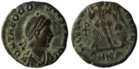 Theodosius I (379-395). Æ . Cyzicus, 388-392. Pearl-diademed, draped and cuirassed bust r. R/ Victory advancing l., head r., carrying trophy and dragg...