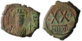PHOCAS (602-610). Half Follis. Nicomedia. Uncertain RY date.
Obv: Crowned facing bust, wearing consular robes and holding mappa and cross.
Rev: Larg...