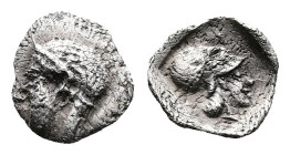 Asia Minor, Uncertain mint. Circa 5th. Century BC. AR Tetartemorion (7mm, 0,16 g.) Head of Apollo with late archaic look to left. Rev. Helmeted head o...