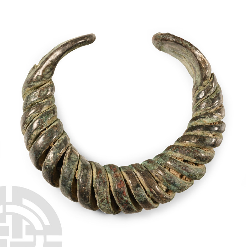 9th-11th century A.D. Substantial penannular type with looped finials. 162 grams...