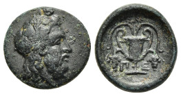 THESSALY. Peparethos. Chalkous (4th-3rd centuries BC).

Obv: Head of Dionysos right, wearing ivy wreath.
Rev: Π - E.
Kantharos containing vine tendril...