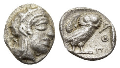 ATTICA. Athens. Obol (circa 454-404 BC).

Obv: Helmeted head of Athena right, with frontal eye.
Rev: AΘE
Owl standing right, head facing; olive sprig ...