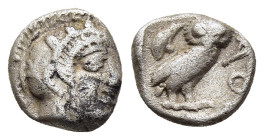 ATTICA. Athens. Obol (circa 454-404 BC).

Obv: Helmeted head of Athena right, with frontal eye.
Rev: AΘE
Owl standing right, head facing; olive sprig ...