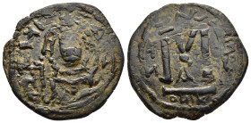 SASANIANS. Khosrau II, 591-628. Follis.

Obv: Crude bust of Heraclius facing.
Rev: Large M, officin A below, oNIK in exergue.

Imitating a Byzantine f...
