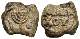 JUDAEA. Lead Seal or Bulla (circa 5th- 7th century AD).

Obv: Seven branched menorah flanked by fish an wine bottle (oinochoe).
Rev: ΜΑΛ/ ΧΟΥ in tw...