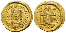 JUSTINIAN I (527-565). GOLD Solidus. Constantinople.

Obv: D N IVSTINIANVS P P AVG
Helmeted and cuirassed bust facing, holding globus cruciger and shi...
