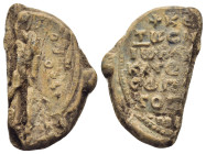 BYZANTINE LEAD SEAL. (26mm, 9,8 g) Obv: Saint standing facing. Rev: Legends in 7 lines.