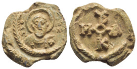 BYZANTINE LEAD SEAL. (26mm, 11.5 g) Obv: Facing nimbate bust of Saint, all within wreath. Rev: Cruciform monogram.