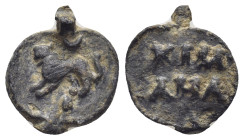 ASIA MINOR. Uncertain. Amulet (Lead, 13mm, 1.48 g). Lion standing left, crescent above. Rev. Legends in two lines.