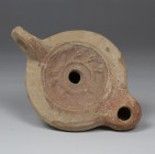 Roman factory oil lamp depicting Myrtle wreath with makers mark, Type Bussière D II 1