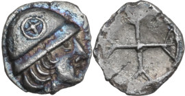 Celtic World. Gaul, Massalia. AR Obol, c. 5th century BC. Obv. Helmeted male head right; wheel on helmet. Rev. Wheel with four spokes. Depeyrot, Hellé...