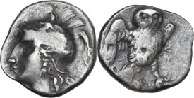 Greek Italy. Southern Apulia, Tarentum. AR Drachm, c. 281-272 BC. Obv. Helmeted head of Athena left with hair flowing down behind. Rev. Owl standing t...