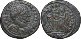 Uncertain Germanic tribe. Pseudo-Imperial coinage. AE, Barbaric imitation. Obv. Helmeted and cuirassed bust right, with shield and spear. Rev. Two Vic...