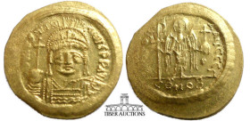 Justinian I. 527-565. AV Solidus. Constantinople mint, 1st officina. Struck 545-565. Helmeted and cuirassed bust facing, holding globus cruciger and s...