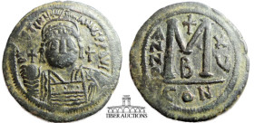 Justinian I. 527-565. Æ Follis. Dated RY 15 (542/3). helmeted and cuirassed bust facing, holding globus cruciger in left hand and shield in right; cro...