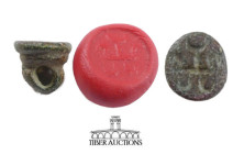 Mesopotamia. Bronze alloy stamp seal . 1st millennium BC. With geometric base, possibly of a man's face. 11 mm x 11 mm, 3.31 g.
